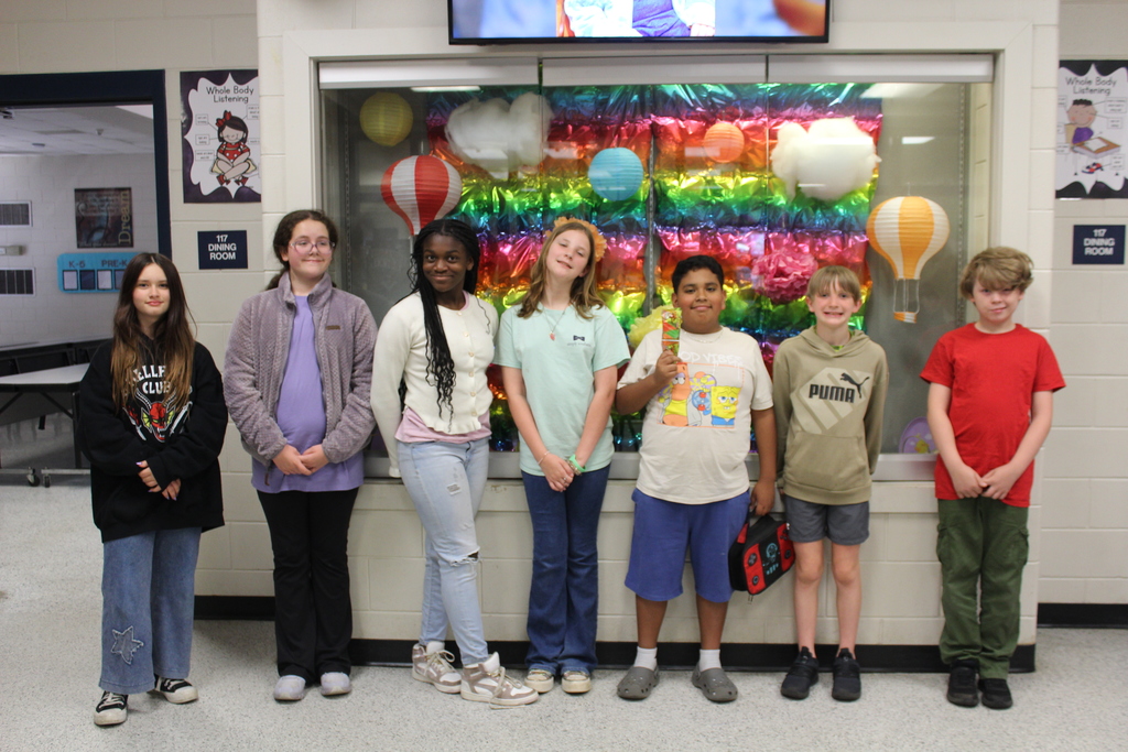 Students and staff dressed colorfully for World Art Day. 
