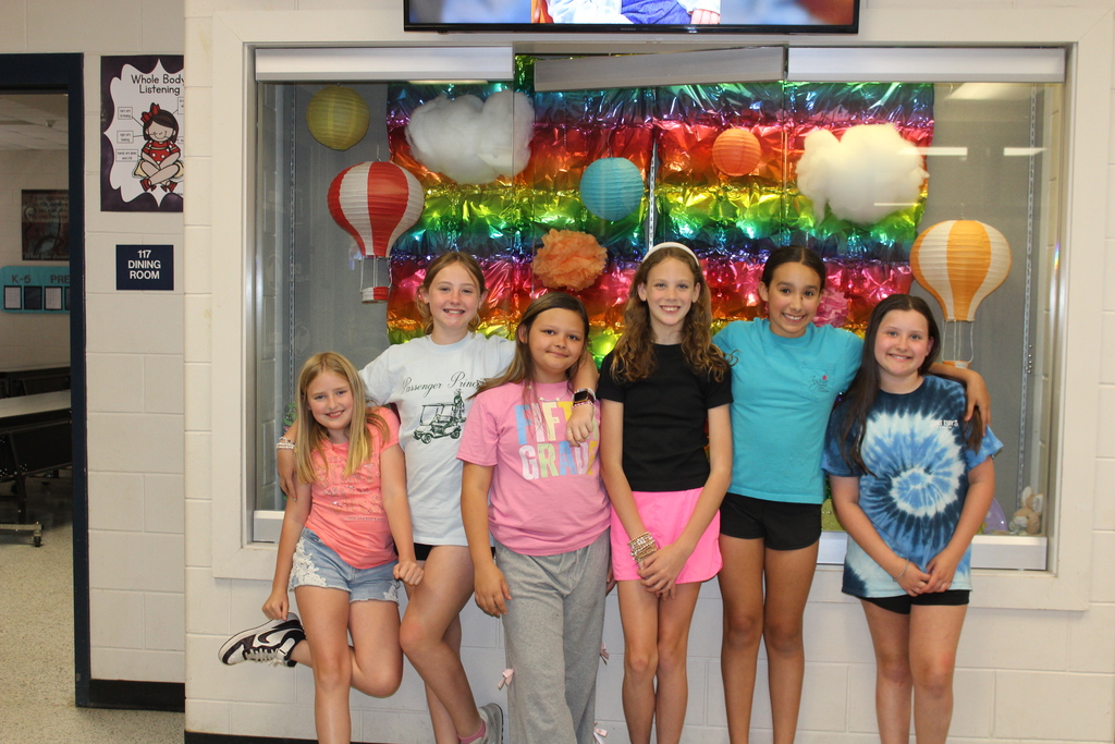 Students and staff dressed colorfully for World Art Day. 