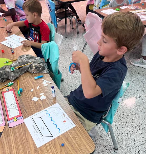 Mrs. Webster's Kindergarten class cutting and gluing and making predictions.