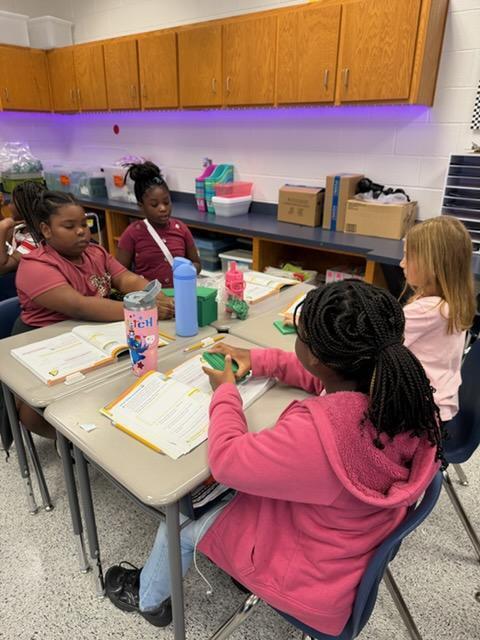 4th Graders learning Math with hands on.