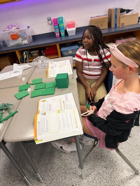 4th Graders learning Math with hands on.