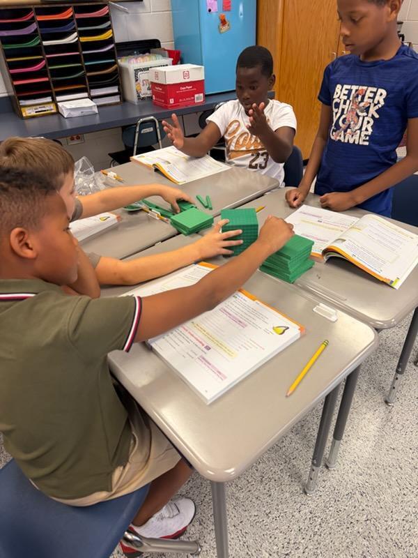 4th Graders learning Math with hands on.