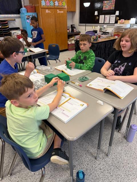 4th Graders learning Math with hands on.