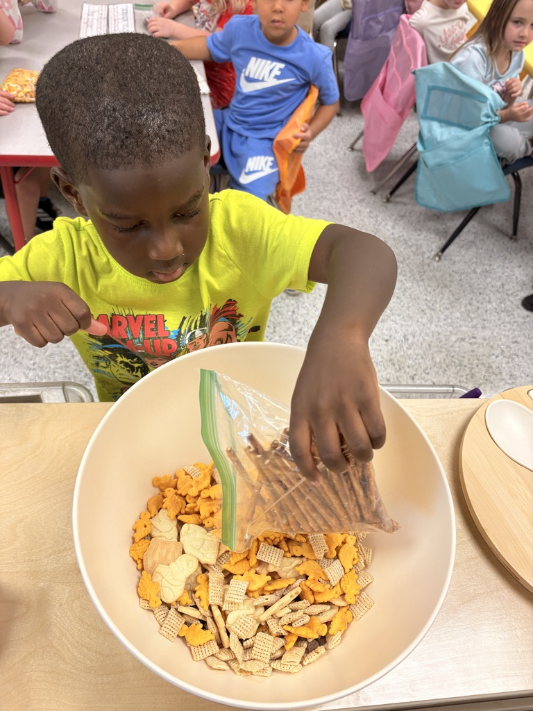 Students make friendship trail mix. 
