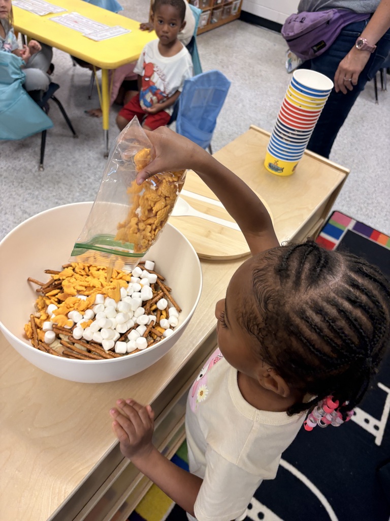 Students make friendship trail mix. 