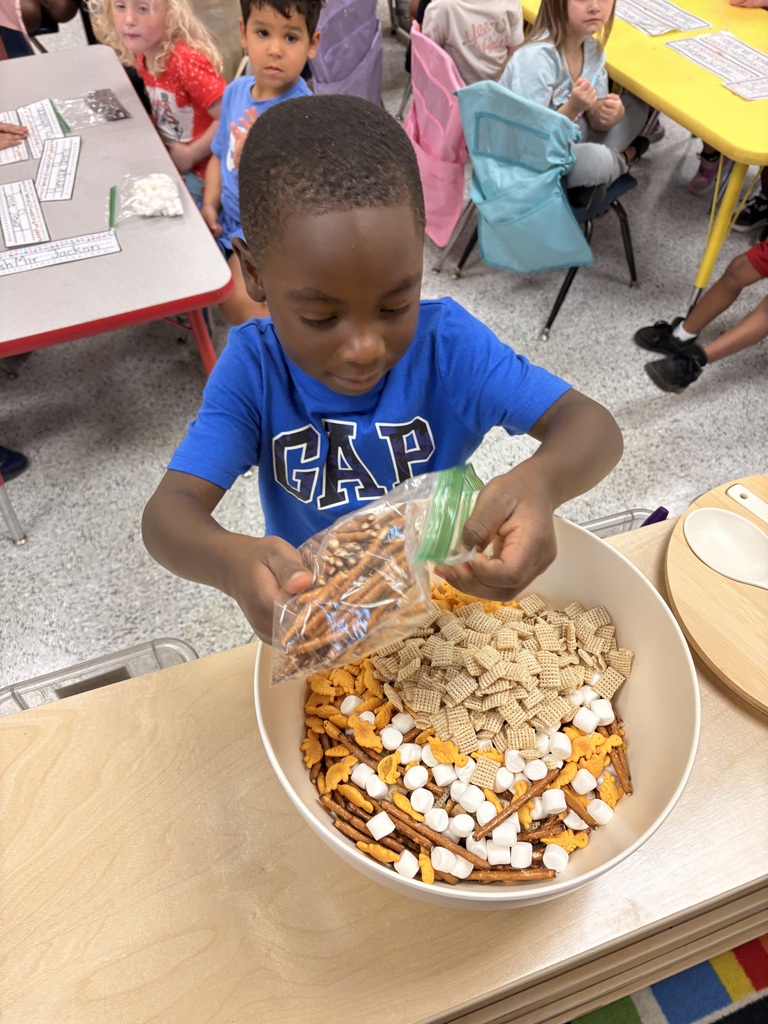Students make friendship trail mix. 
