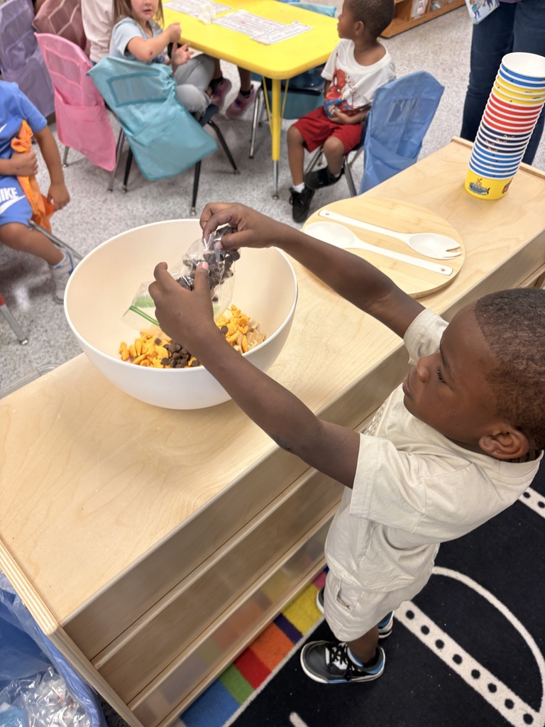 Students make friendship trail mix. 
