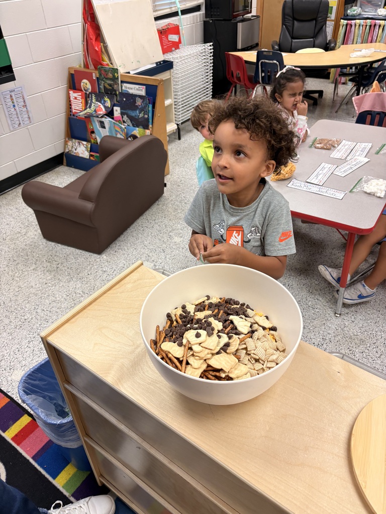 Students make friendship trail mix. 