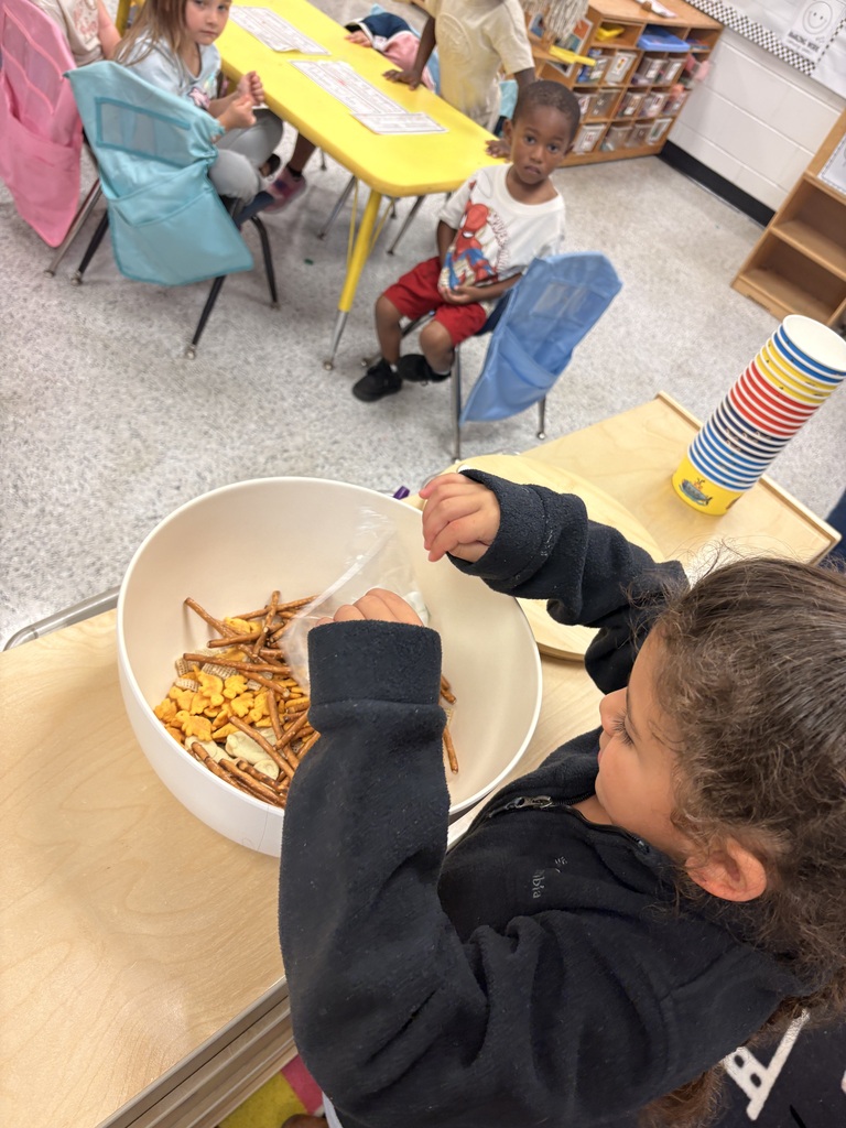 Students make friendship trail mix. 