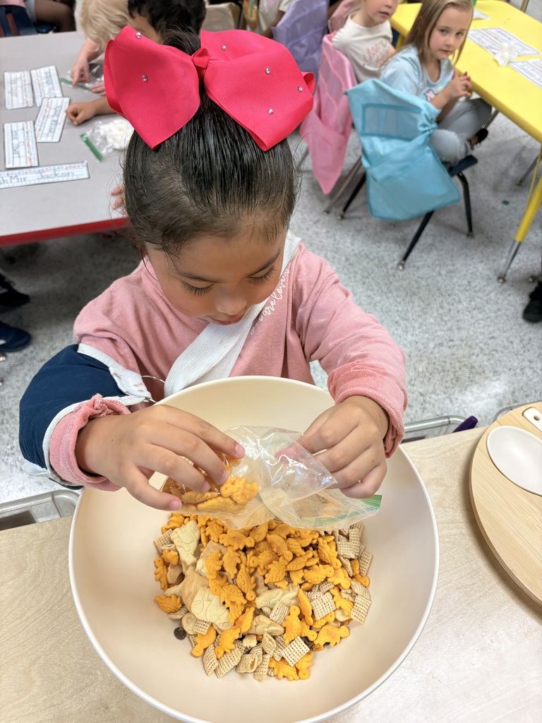 Students make friendship trail mix. 