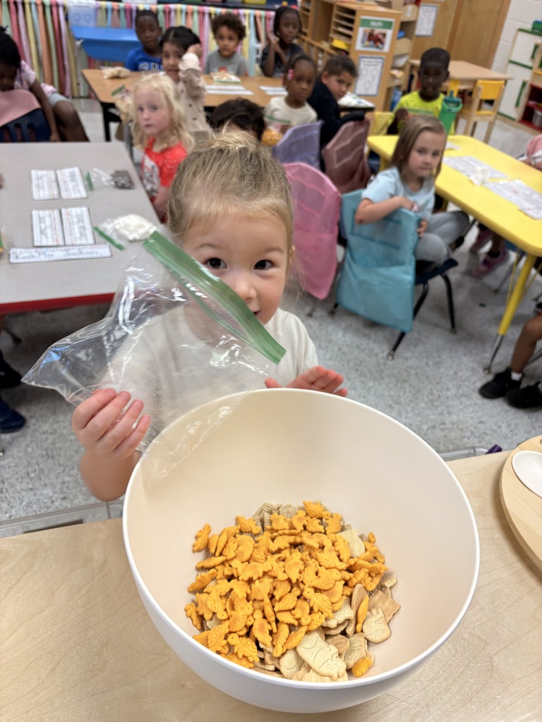 Students make friendship trail mix. 