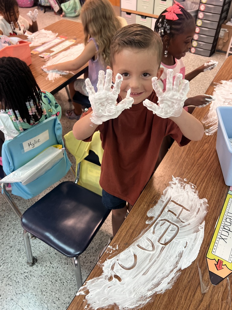 Webster's Kindergarten class enjoying snow cones and writing their names in shaving cream.