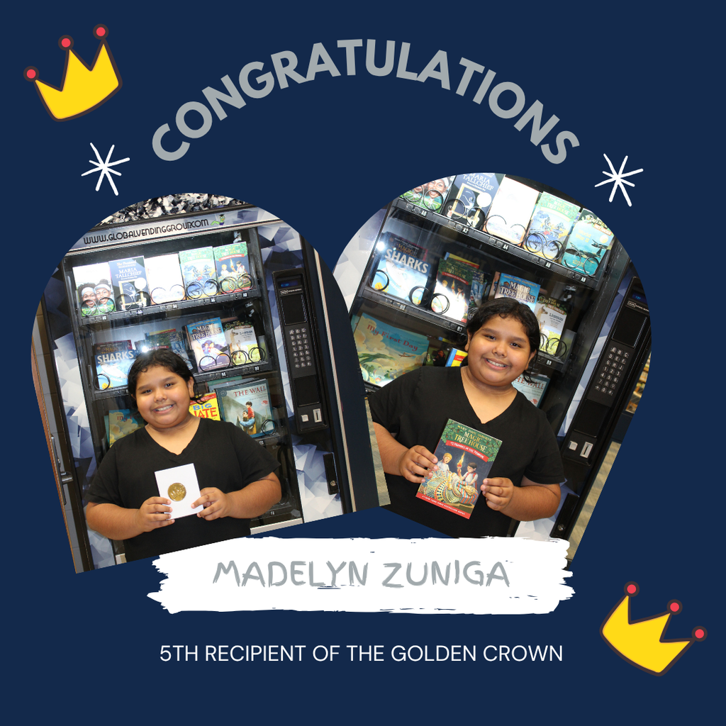 Omega Elementary School golden crown recipient for a free book from the vending machine.