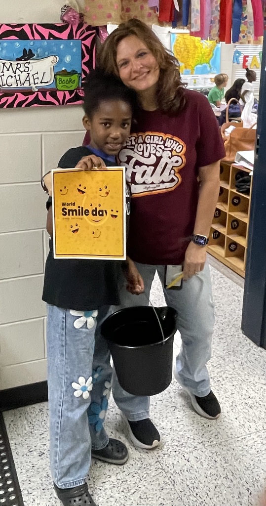 Omega Elementary School Kindness Squad delivering smiles on world smile day.