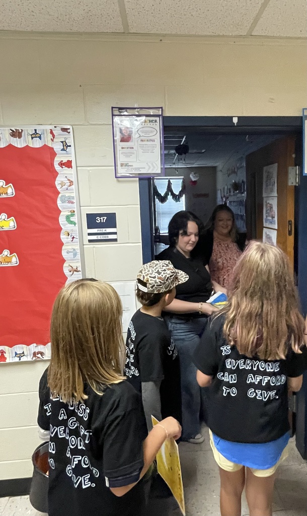 Omega Elementary School Kindness Squad delivering smiles on world smile day.
