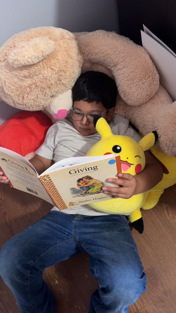 Omega Elementary School students reading at home. 