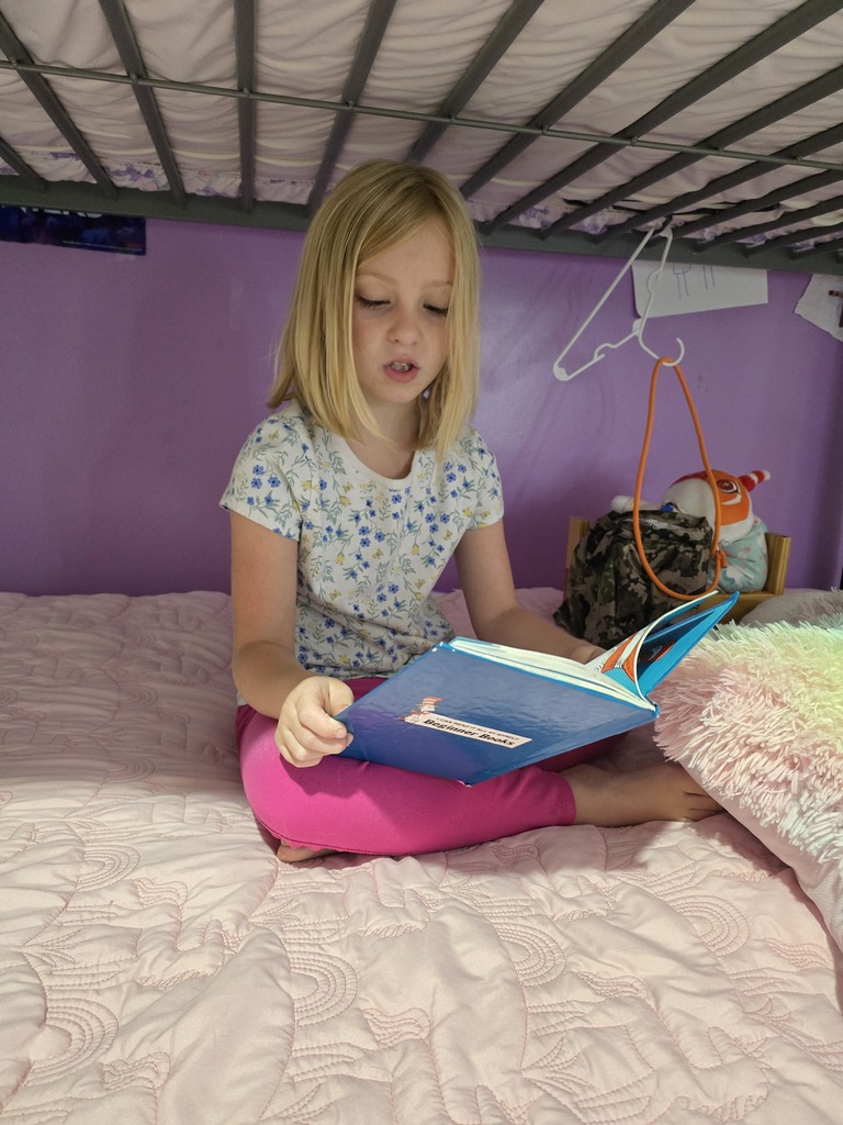 Omega Elementary School students reading at home. 