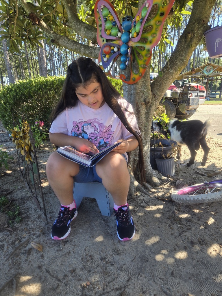 Omega Elementary School students reading at home. 