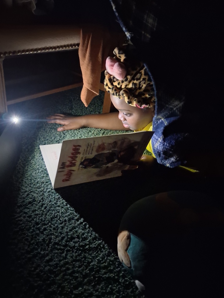 Omega Elementary School students reading at home. 