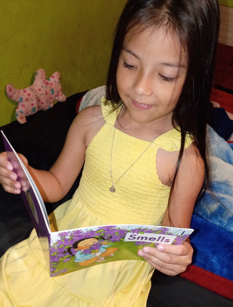 Omega Elementary School students reading at home. 