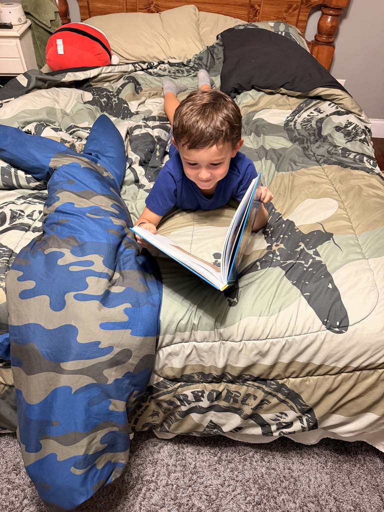 Omega Elementary School students reading at home. 