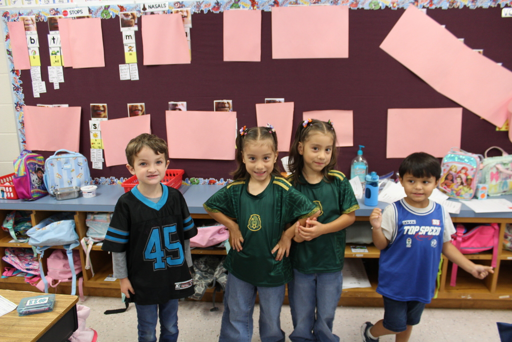 Omega staff and students wearing their favorite team gear.