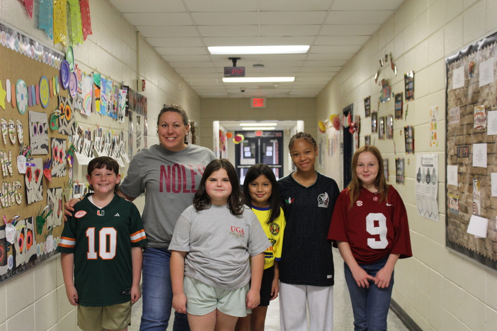 Omega staff and students wearing their favorite team gear.