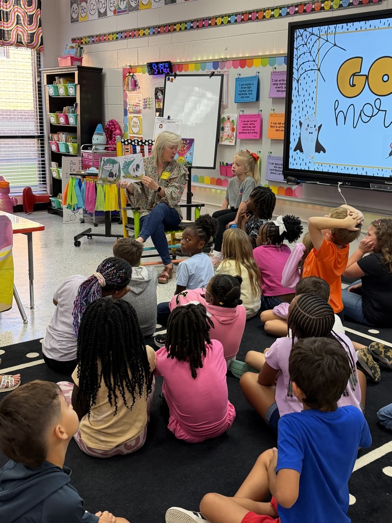 Mrs. Cromer reads to Mrs. Spurlin's second grade class.