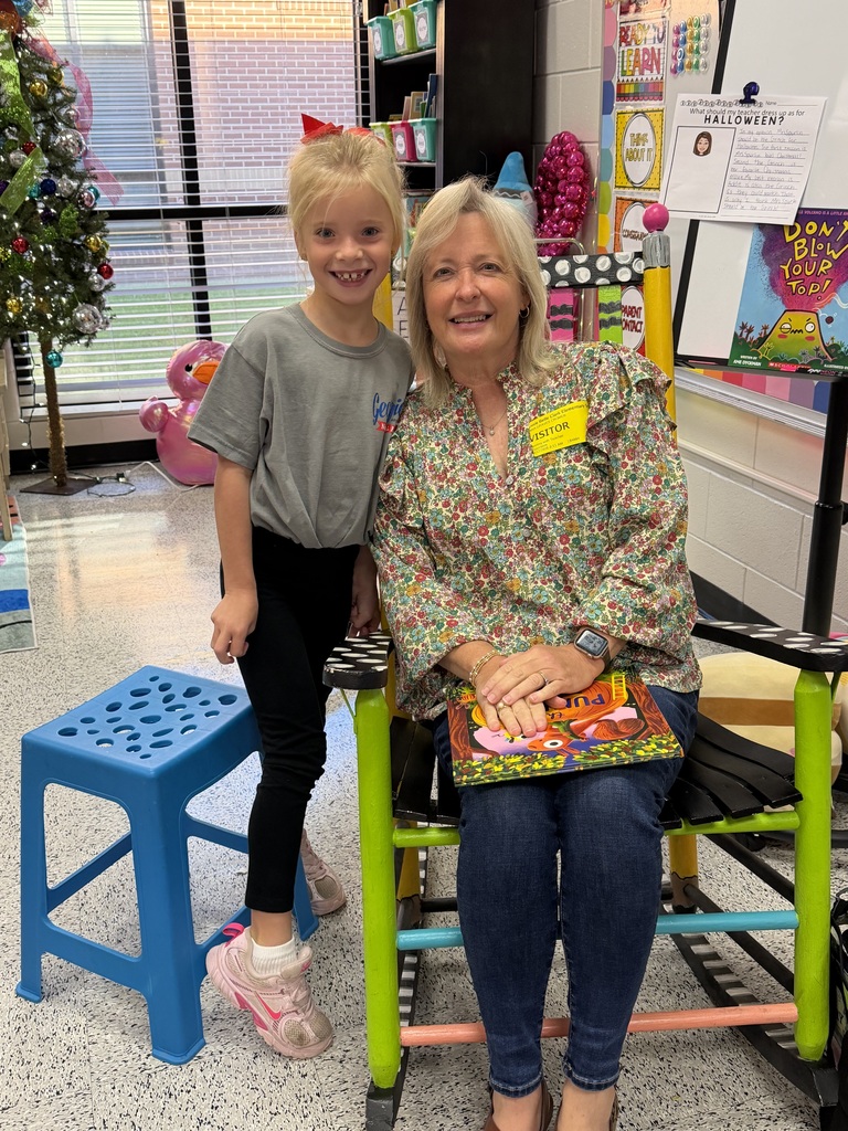 Mrs. Cromer reads to Mrs. Spurlin's second grade class.
