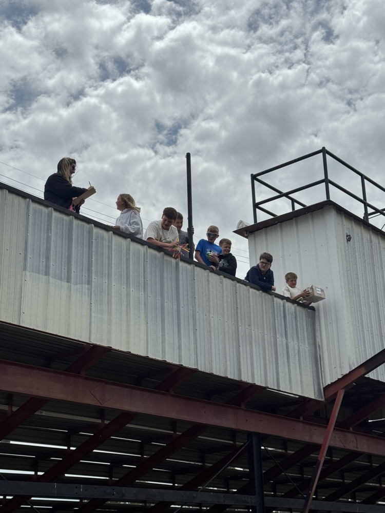 students watching the 6th graders drop their egg drop contraptions from the grand stands