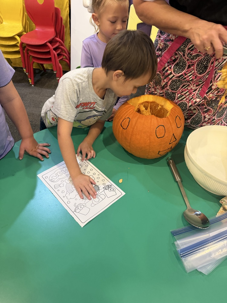 pre-K carving a pumpkin 