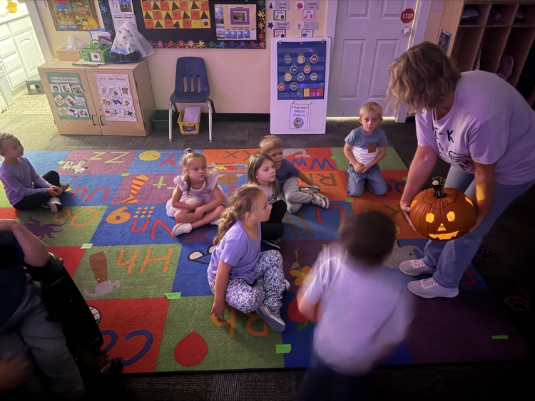 pre-K carving a pumpkin 