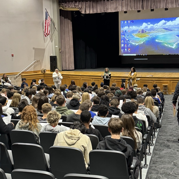 students sitting in auditorium