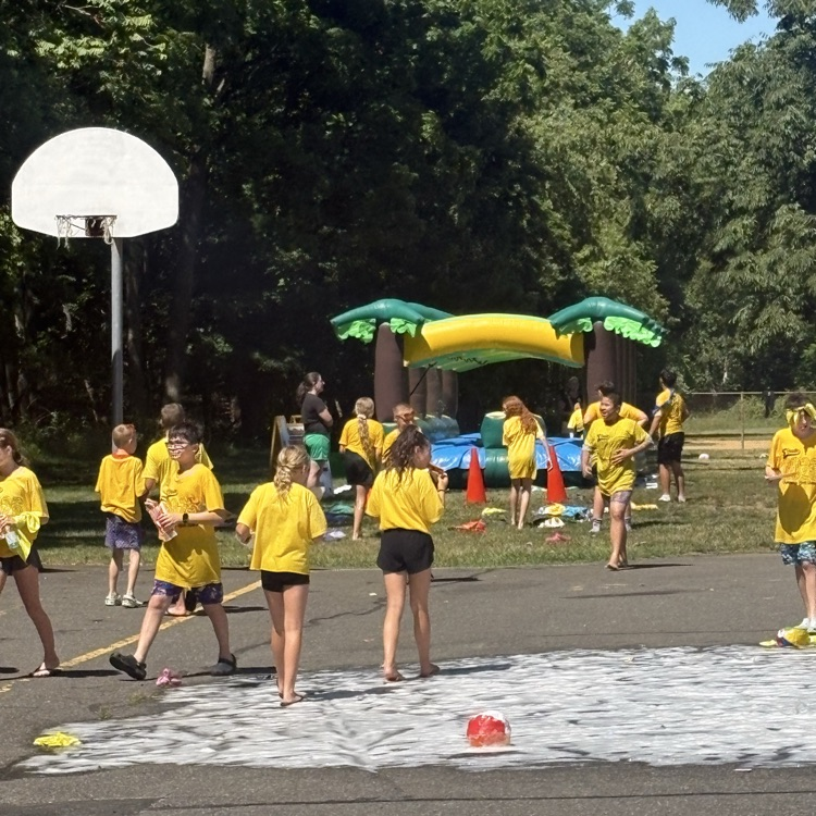 5th grade students walking to the inflatables over the foam 