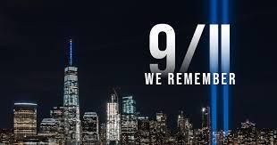 A sign that say 9/11 we remember with the NYC sky line