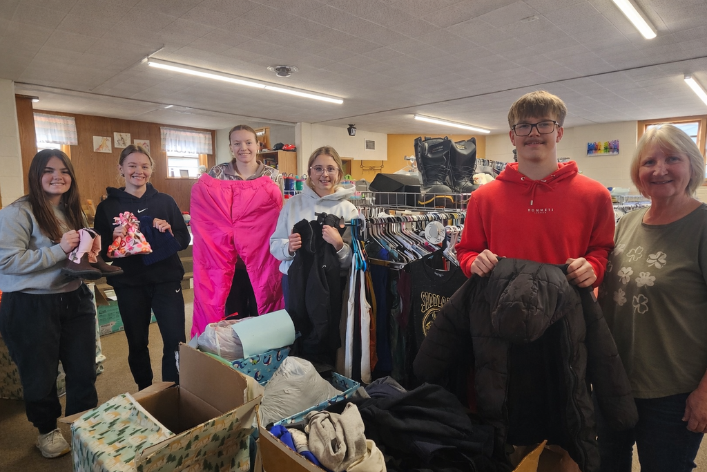 NHS members donating coats to the Clothes Closet