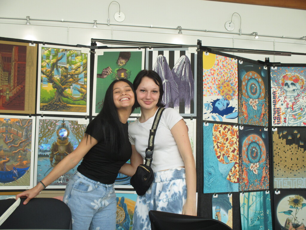 Posing in front of posters by The Graphite Club