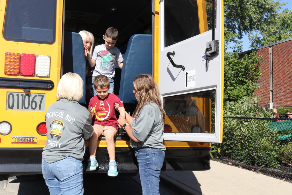 Students learn how to evacuate a bus safely.
