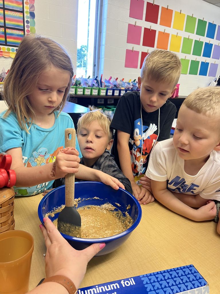 Students are baking a batch of cookie dough.
