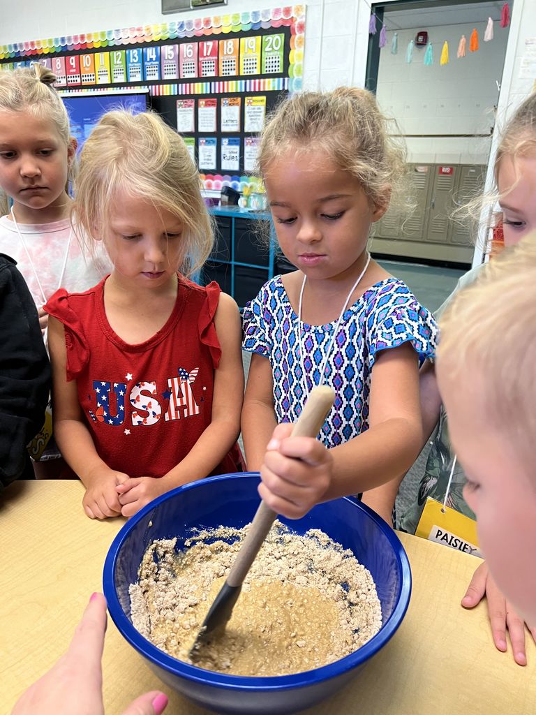 Students are baking a batch of cookie dough.