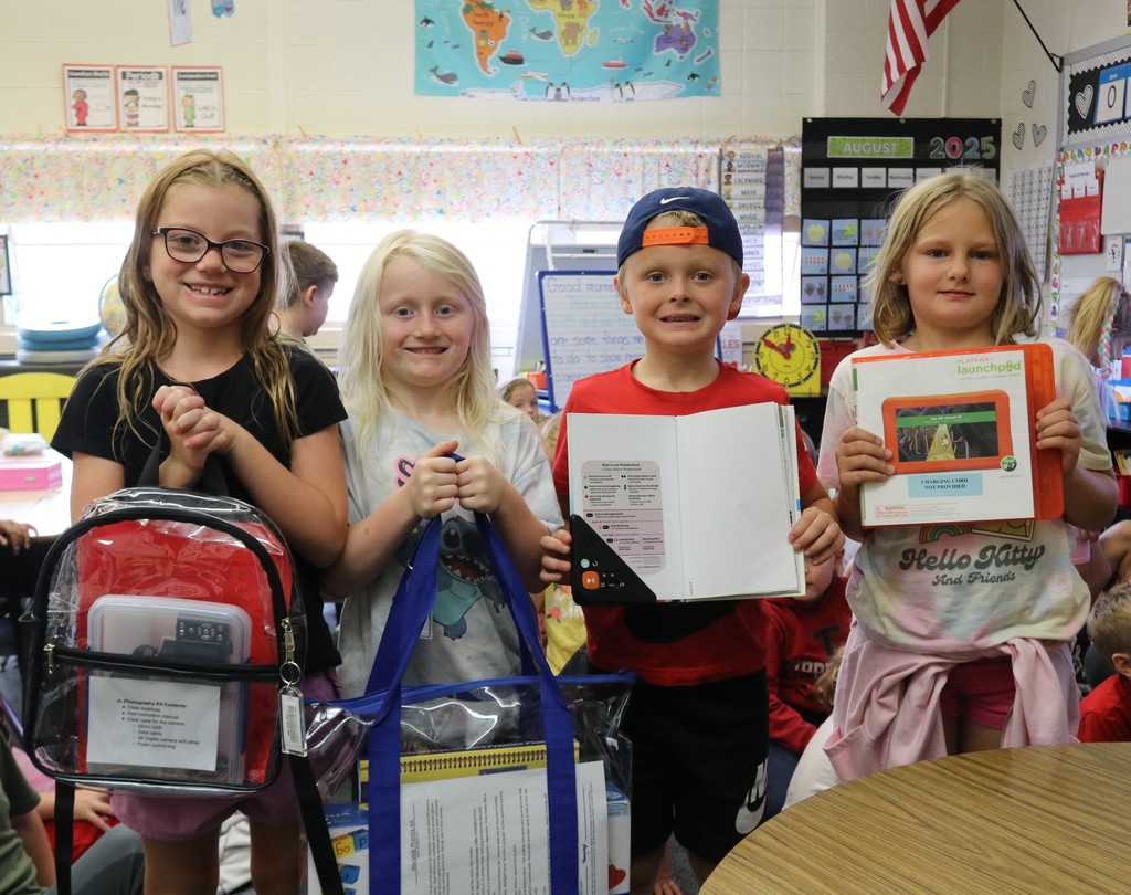 First graders with items from the library.