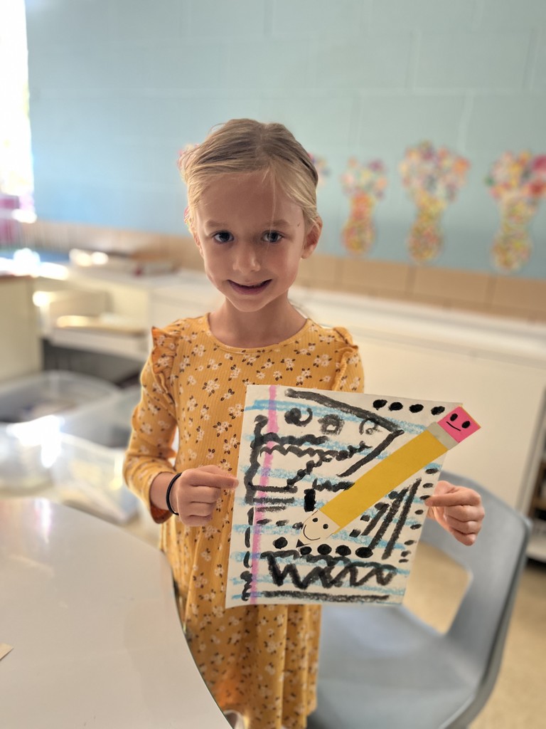 First grader shows off artwork about lines.  