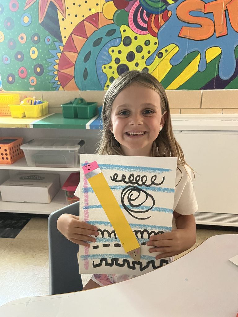 First grader shows off artwork about lines.  