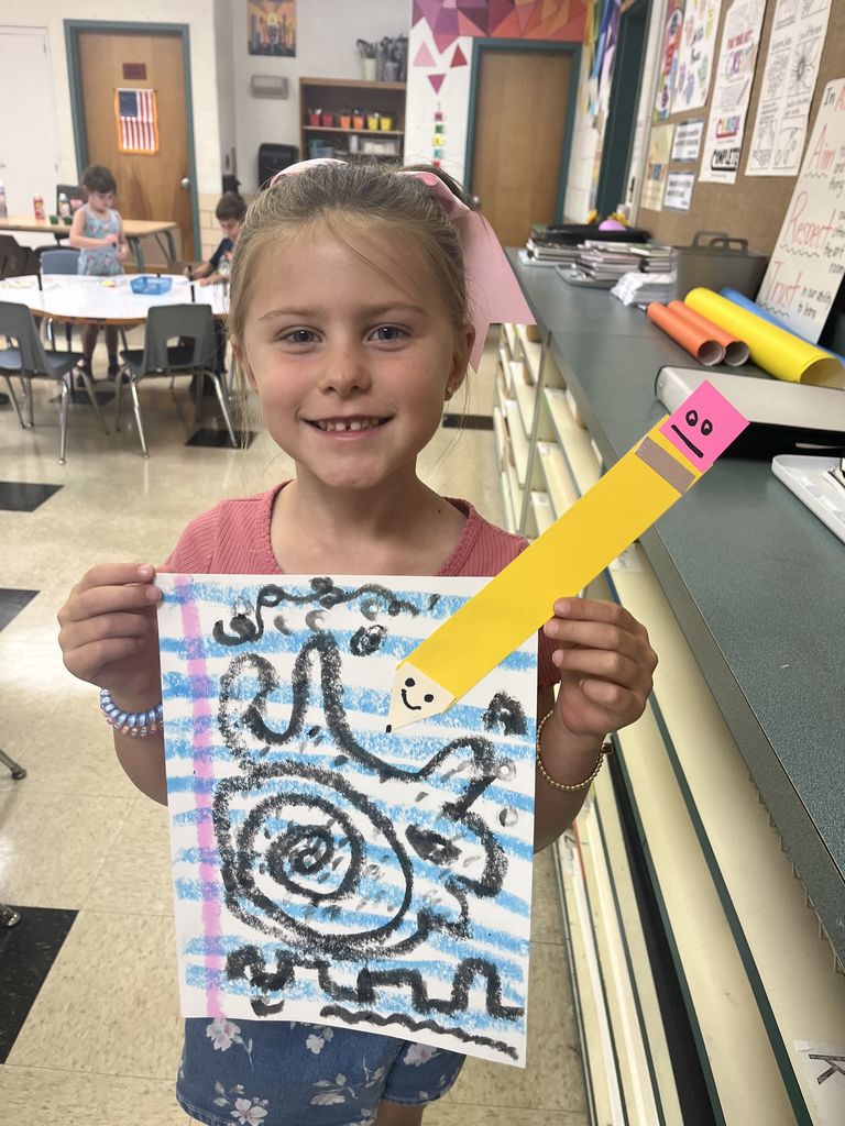 First grader shows off artwork about lines.  
