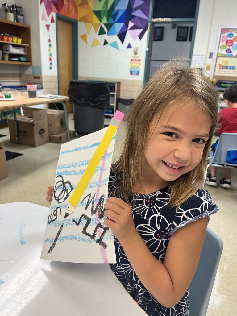 First grader shows off artwork about lines.  