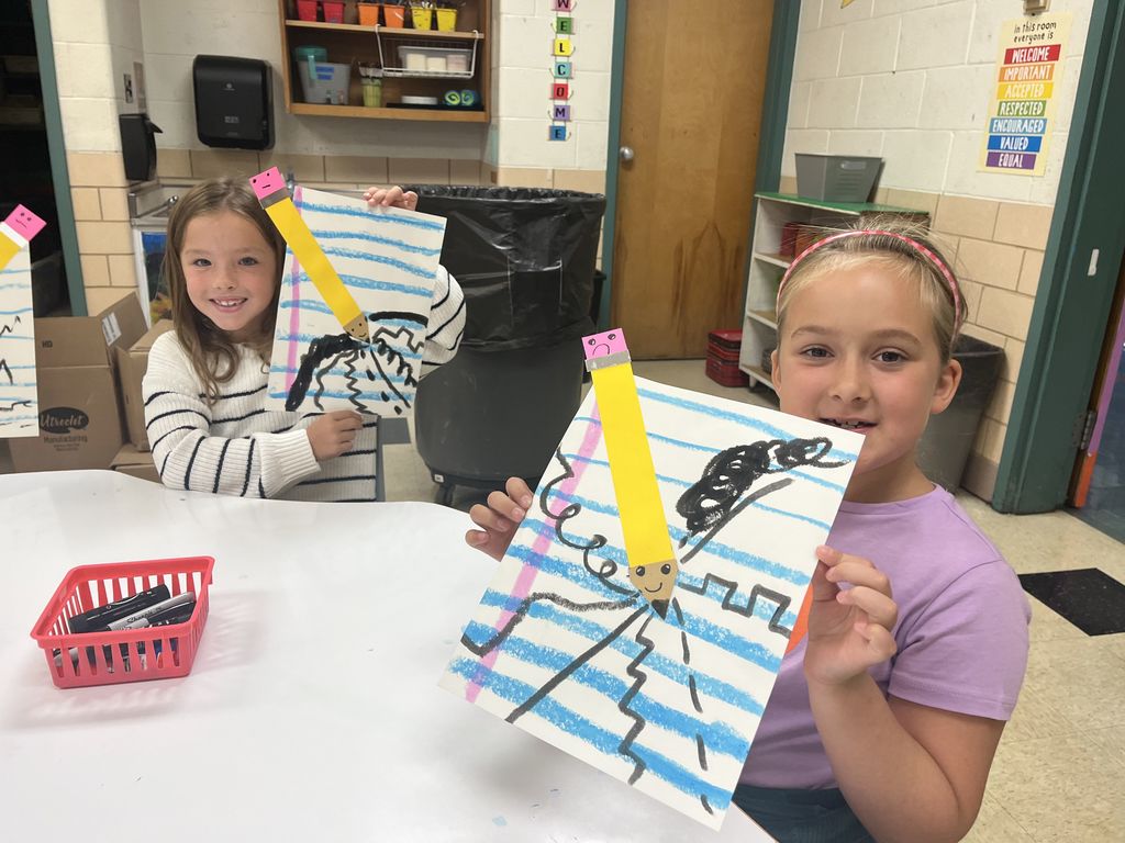 First grader shows off artwork about lines.  