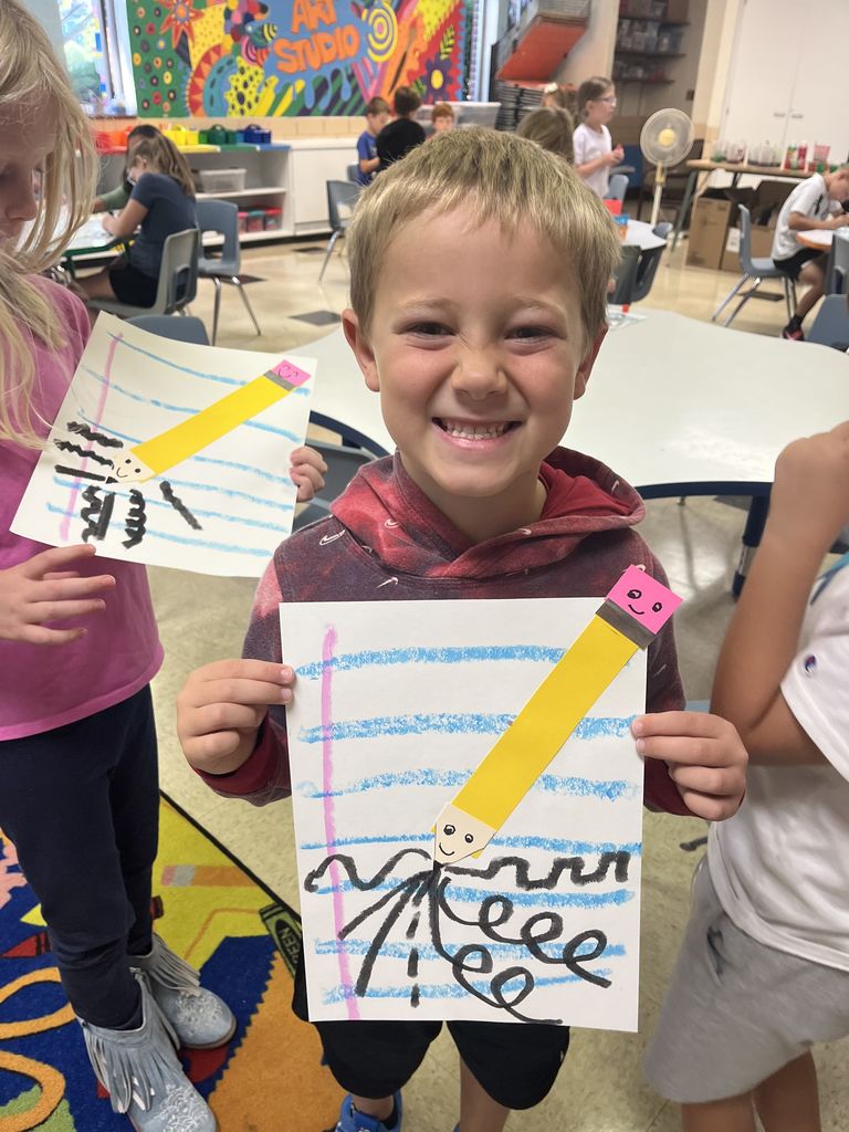 First grader shows off artwork about lines.  