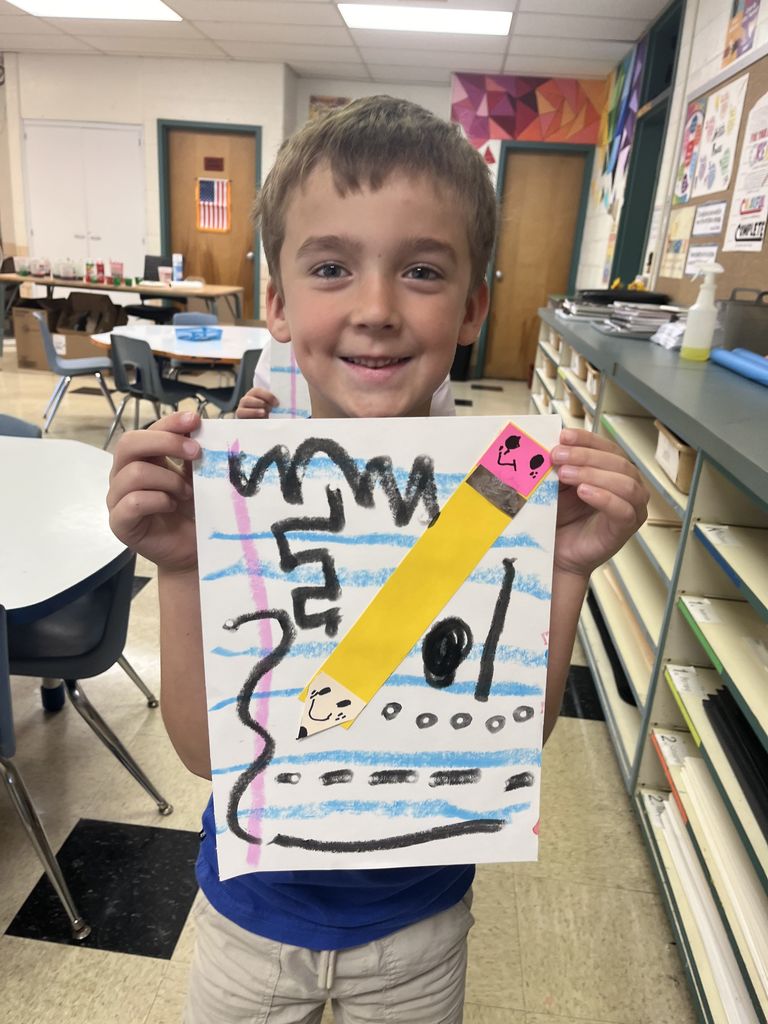 First grader shows off artwork about lines.  