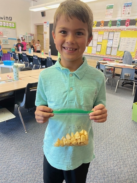 First graders made applesauce to celebrate Johnny Appleseed's birthday.