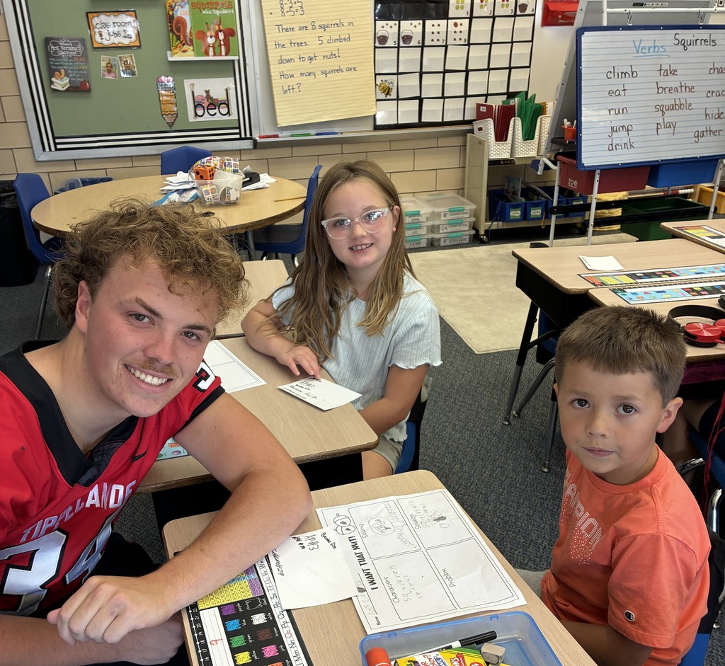 THS varsity football players and cheerleaders visit Broadway students.